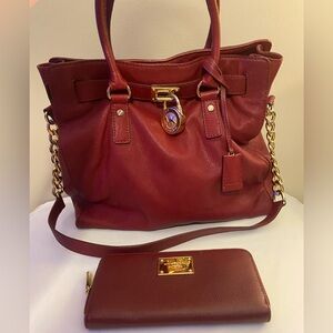 Large Michael Kors red/win colored bag in great condition with matching wallet